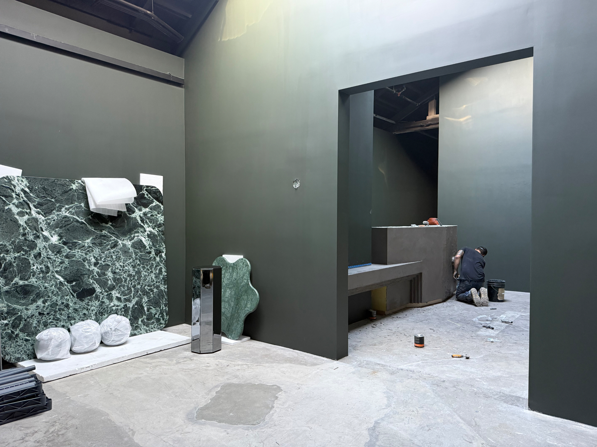 Micro-concrete reception desk and plinth at Erik Lindstrom Rugs, Hollywood Film District — designed by Luis Fernandez, built by Driftwood