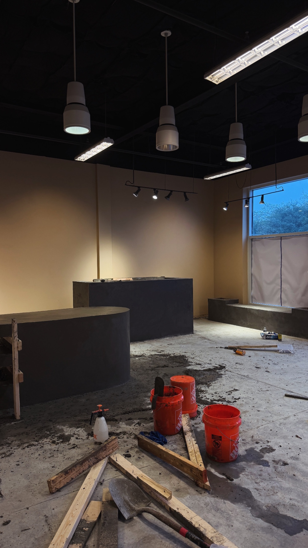 Charcoal micro-concrete bar and bench seating mid-build at The Yard Gym, fabricated by Driftwood