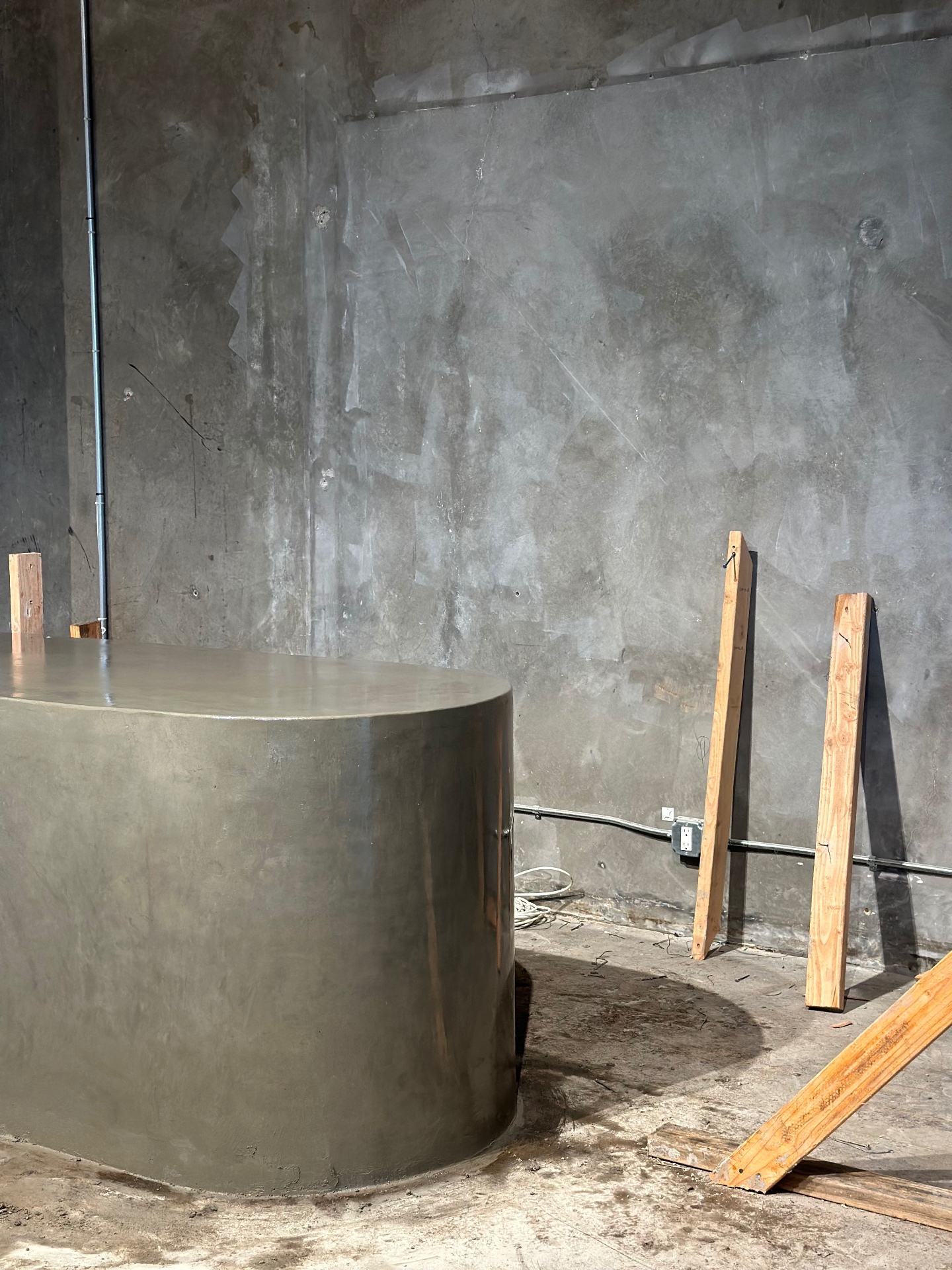 Polished oval micro-concrete bar with curing finish, fabricated by Driftwood