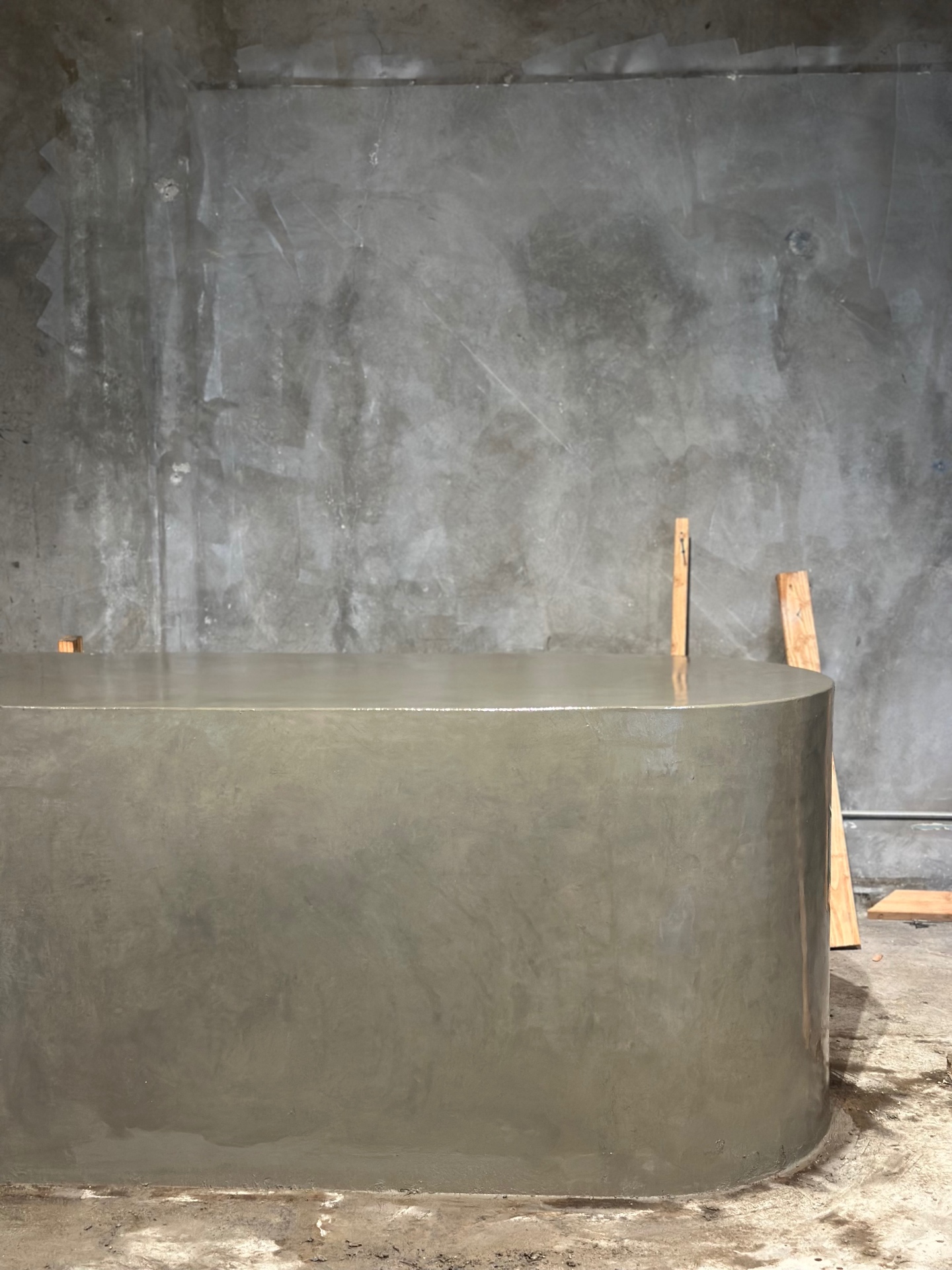 Long curved micro-concrete counter elevation, fabricated by Driftwood