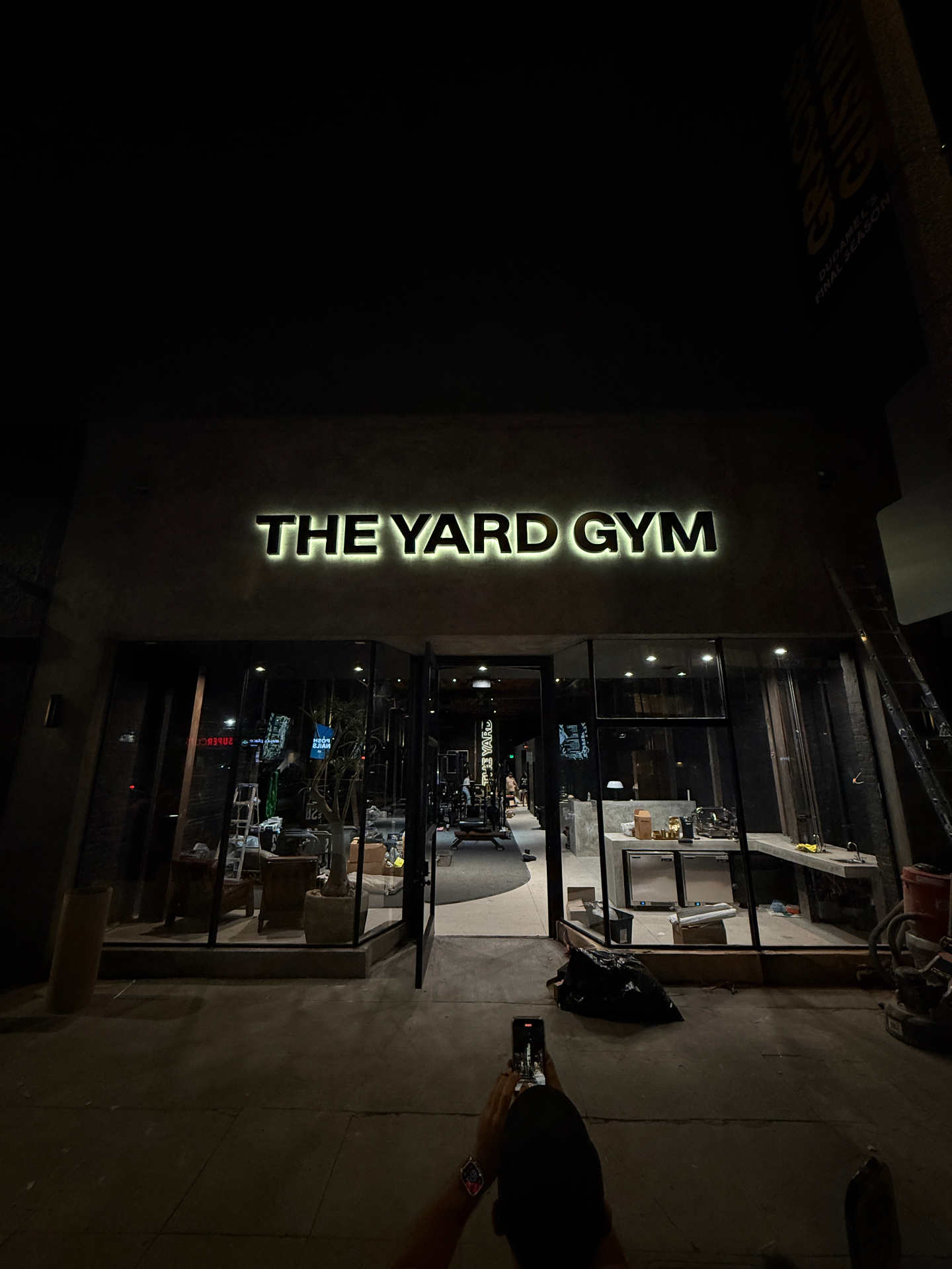 The Yard WeHo at night, illuminated signage